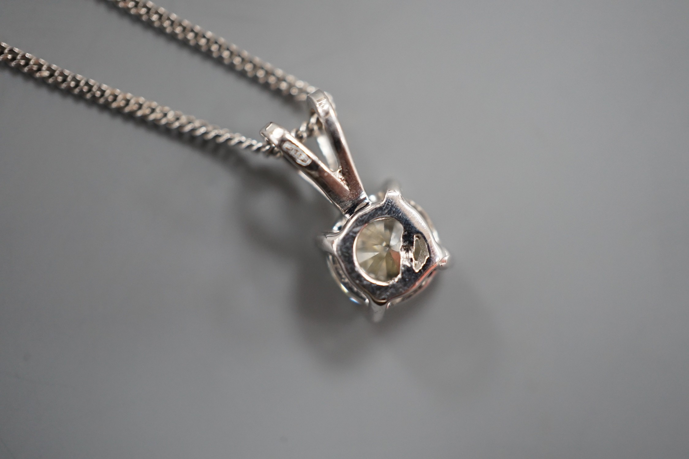 A modern 750 white metal and solitaire diamond set pendant, overall 14mm, on an 18ct white gold fine link chain, 44cm, gross weight 3.3 grams